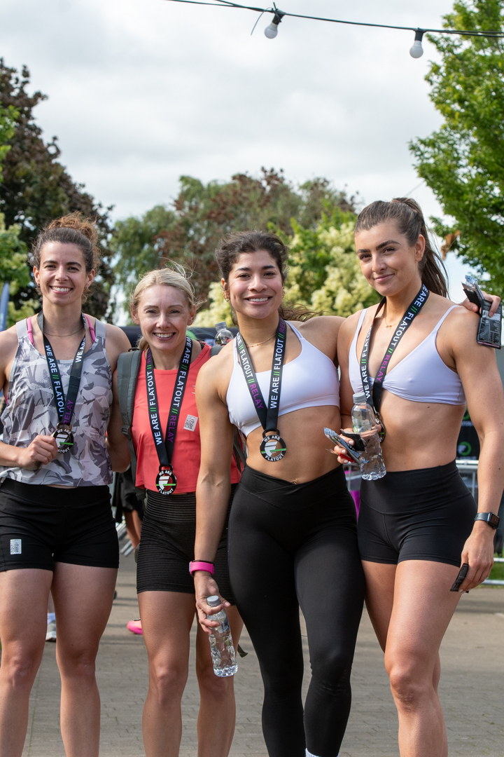 Elite women competitors at a FLATOUT event wearing medals