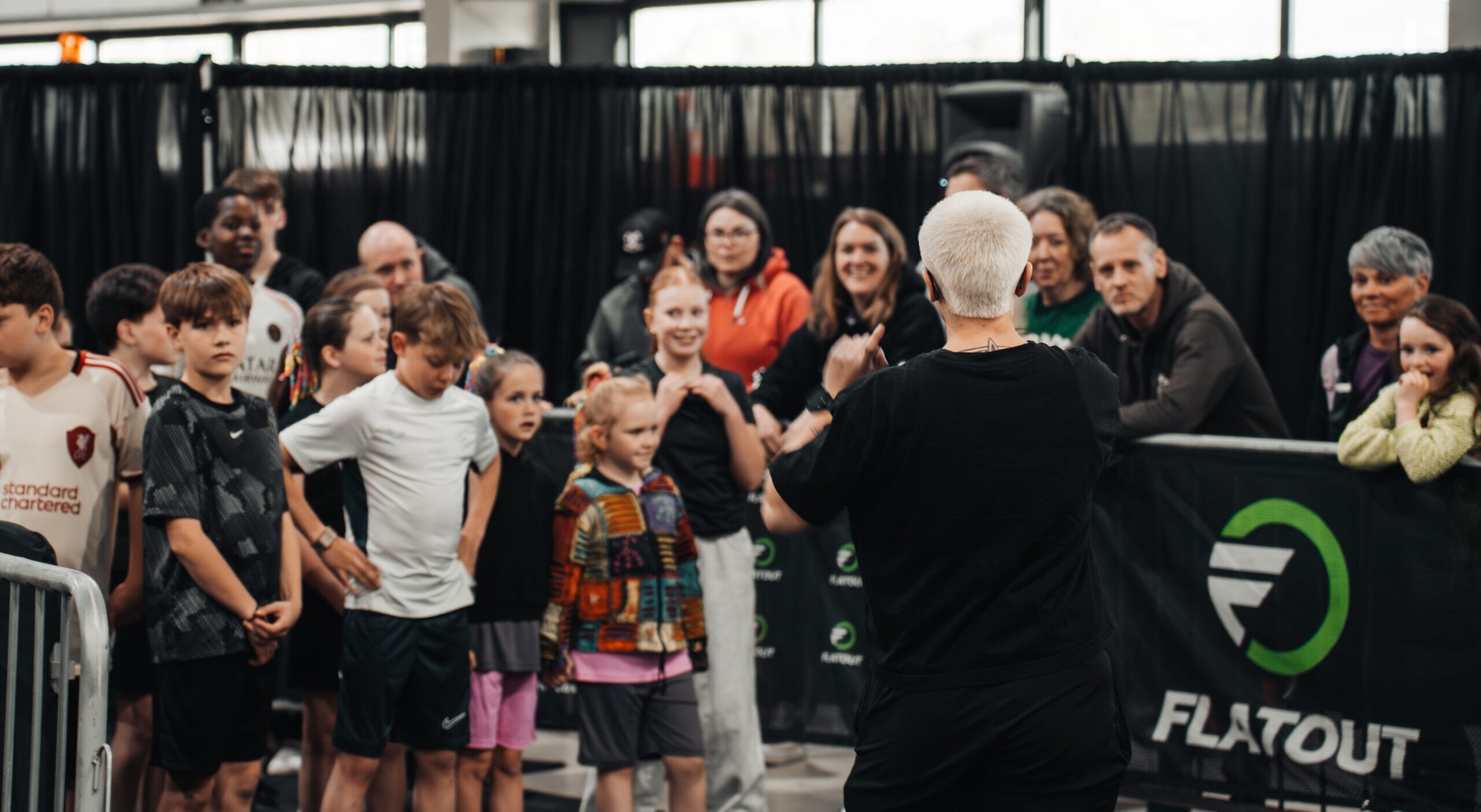 Coach briefing young athletes before a Flatout NextGen race