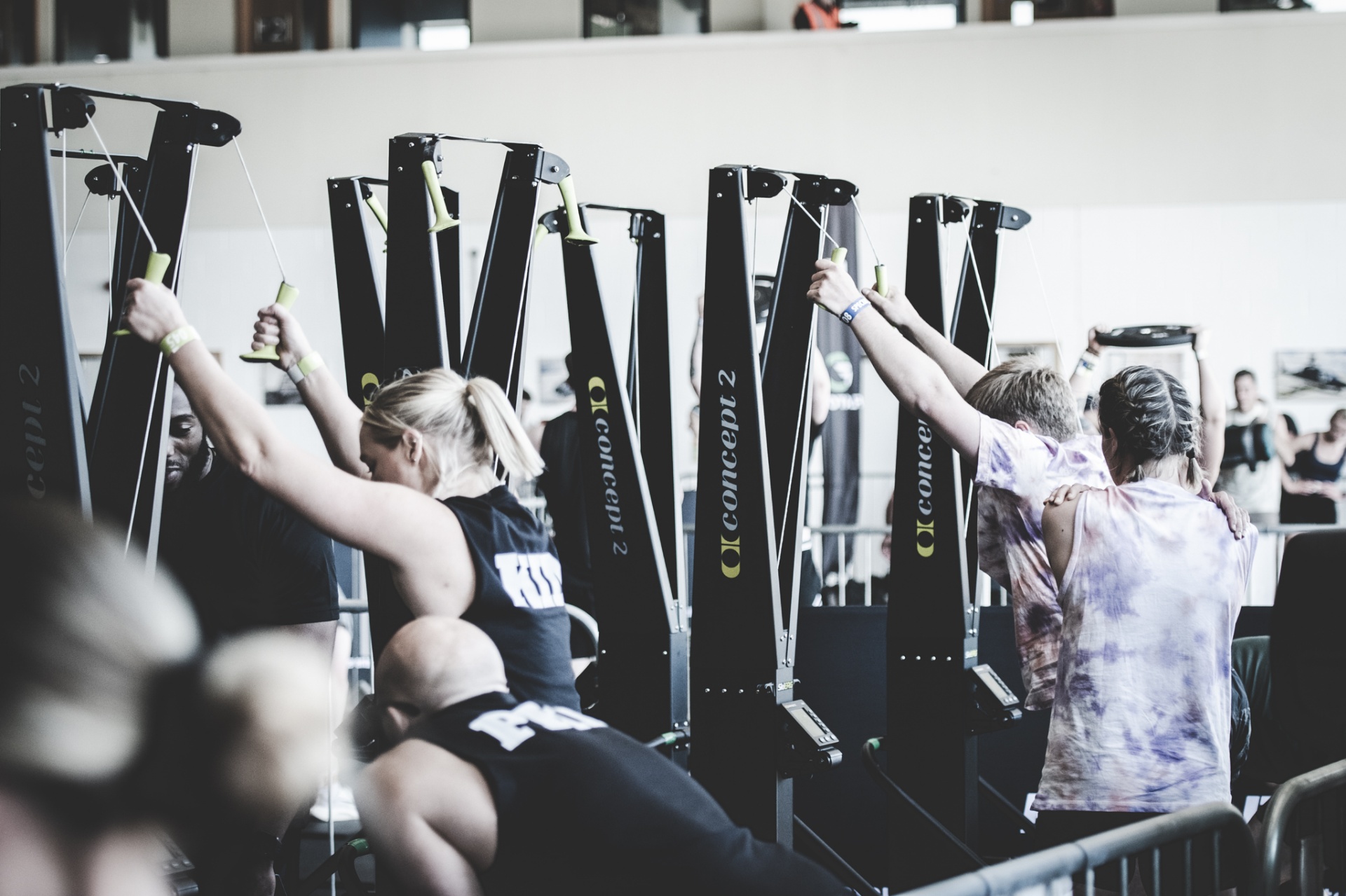 Athletes training on Concept2 machines at a Flatout event